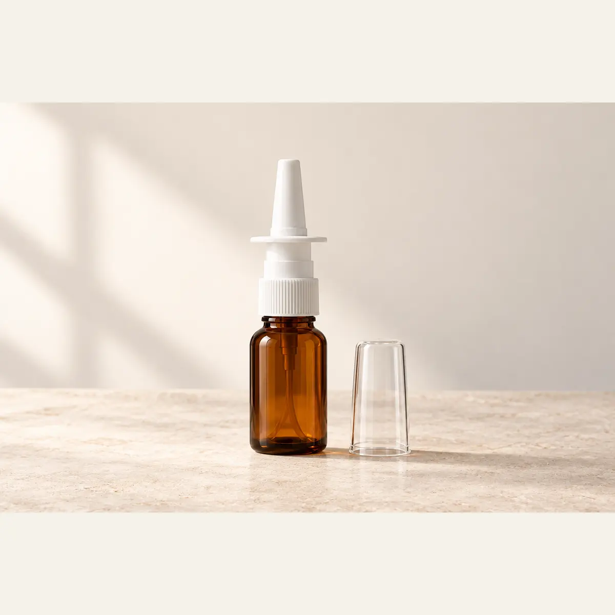 Amber Nasal Spray Bottle photographed on a warm neutral studio background