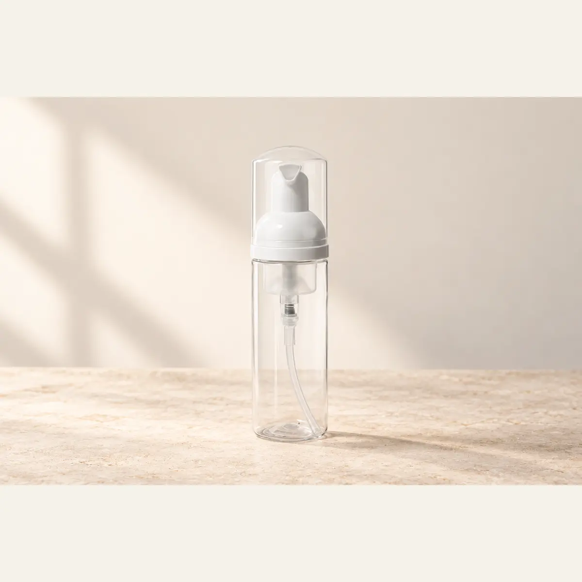 Clear Foaming Pump Bottle photographed on a warm neutral studio background