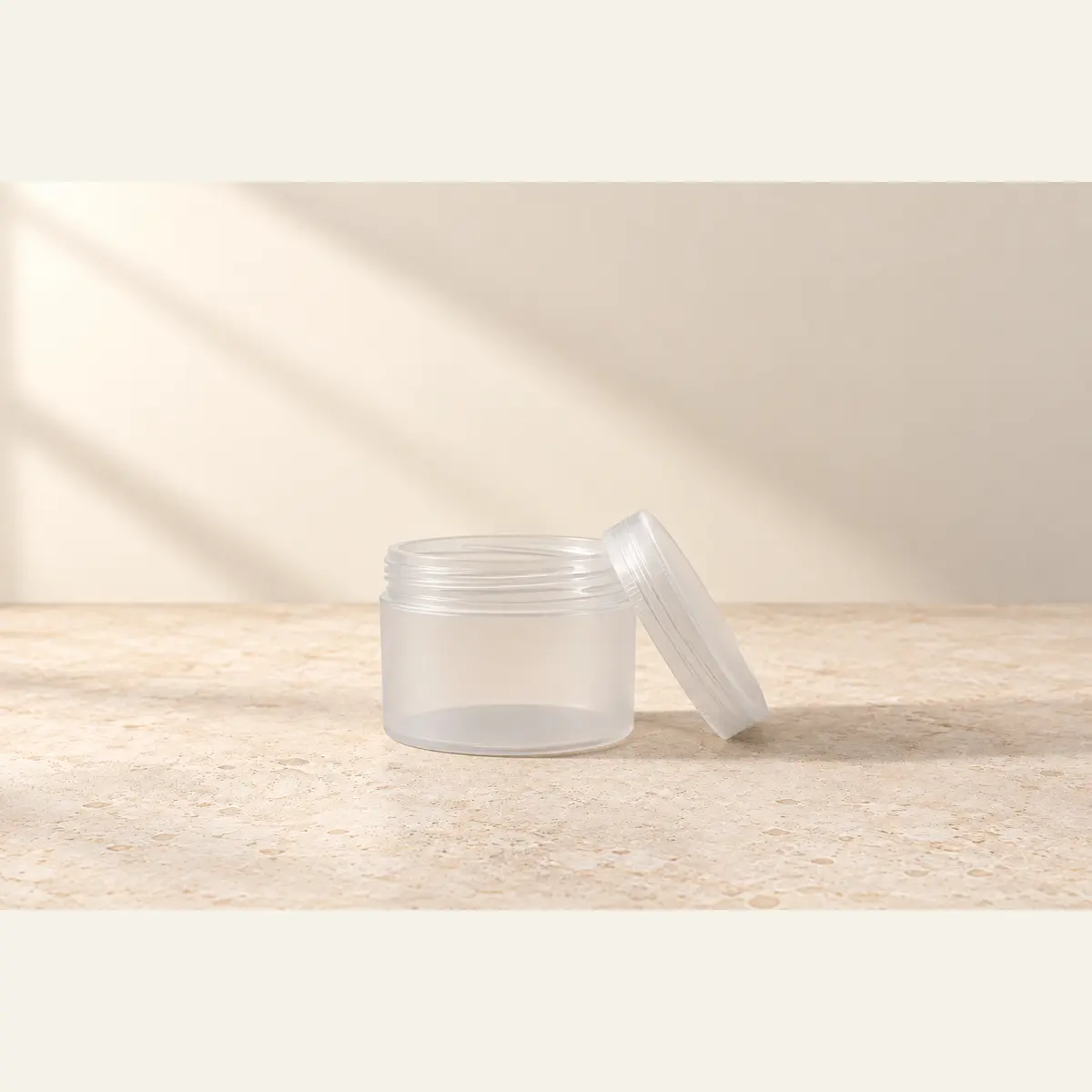 Natural 125 g Cosmetic Jar · Natural Lid photographed on a warm neutral studio background