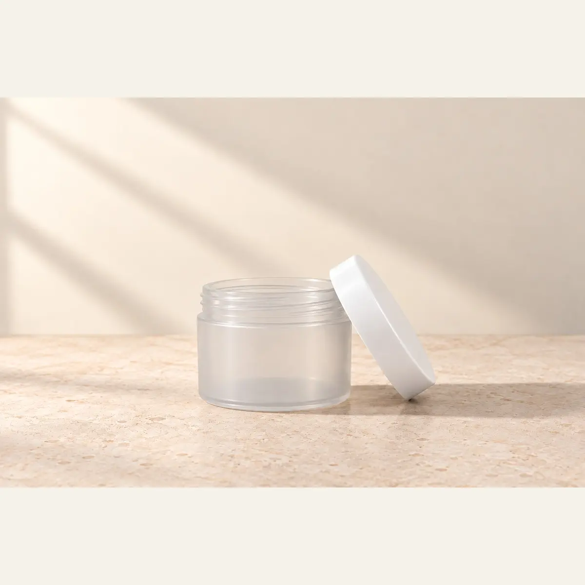 Natural 125 g Cosmetic Jar · White Lid photographed on a warm neutral studio background