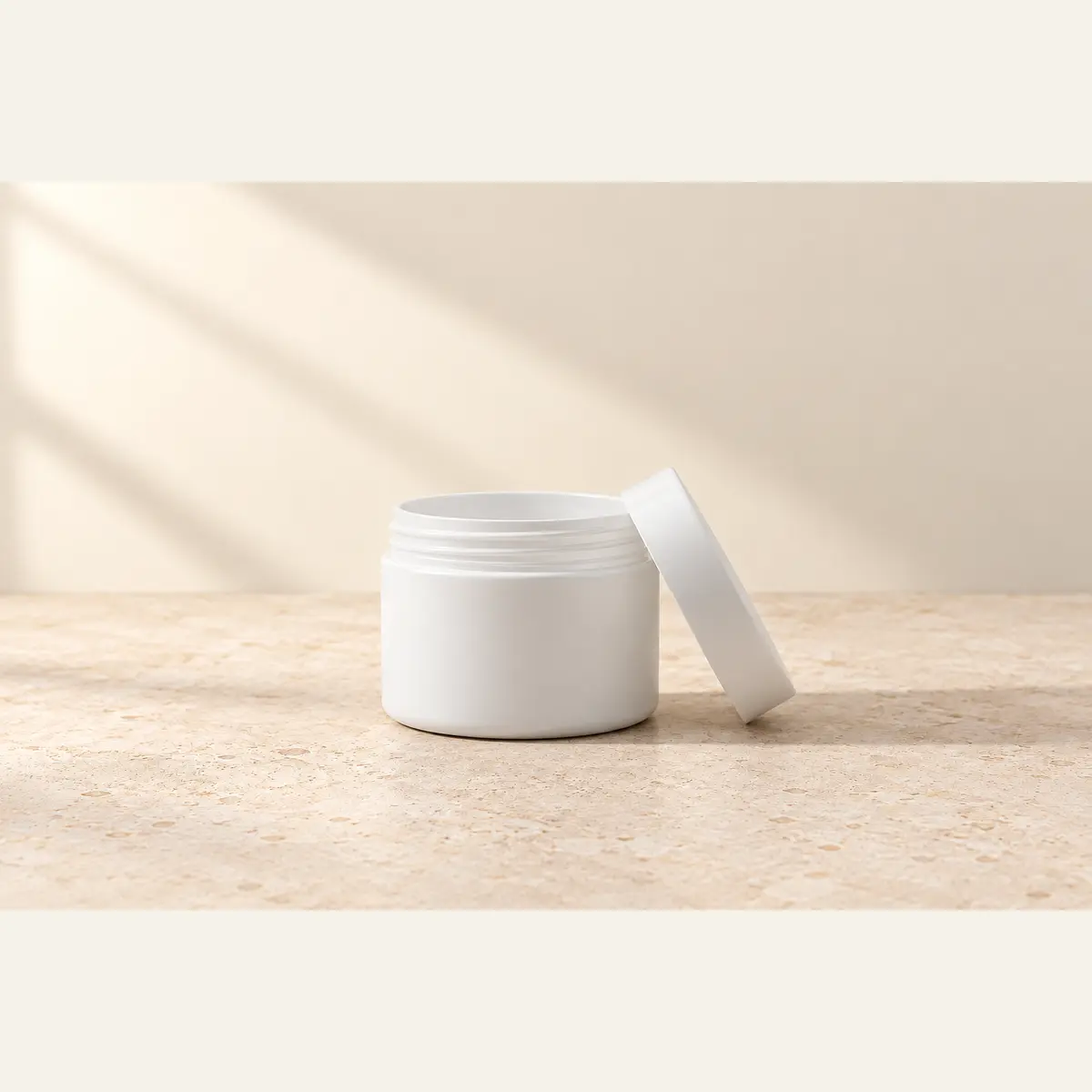 White 125 g Cosmetic Jar · White Lid photographed on a warm neutral studio background