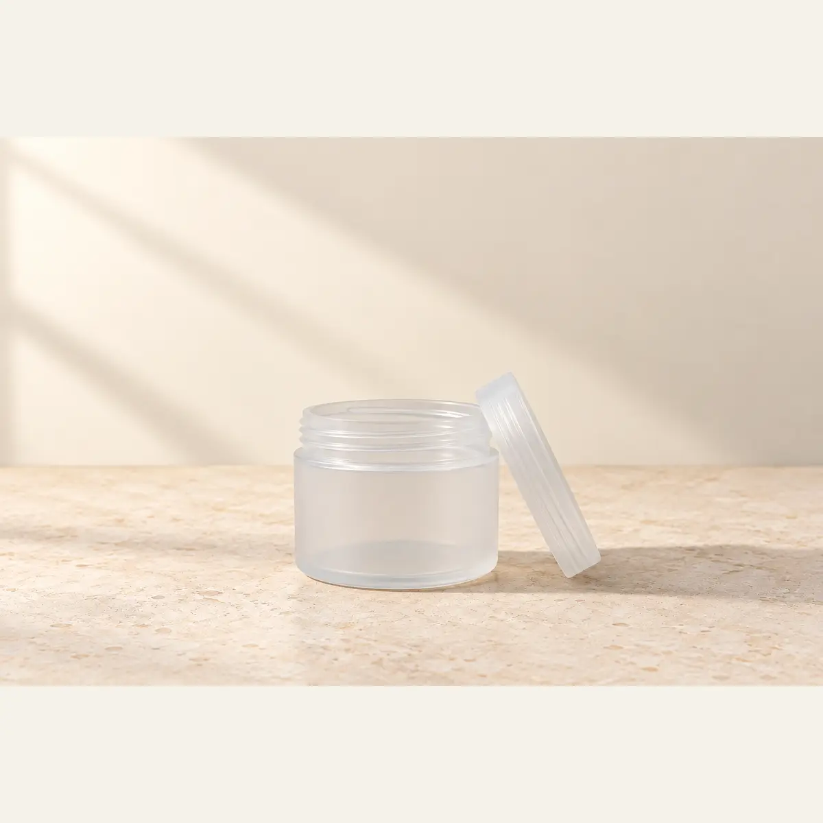 Natural 50 g Cosmetic Jar · Natural Lid photographed on a warm neutral studio background