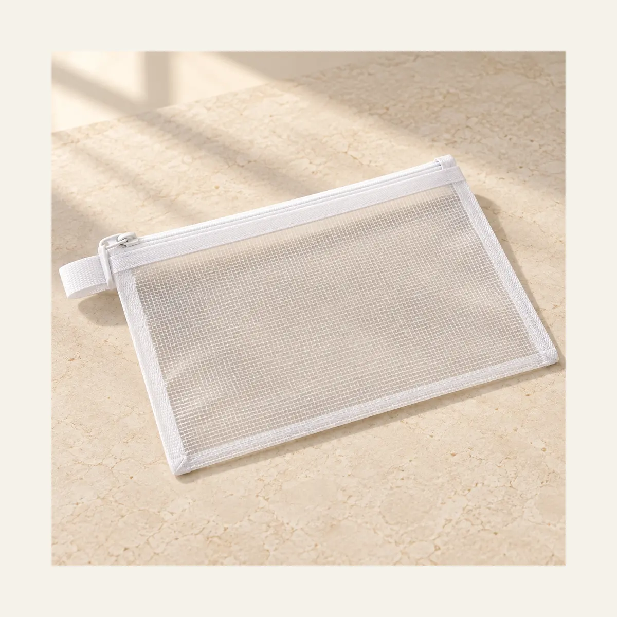 Mesh Organiser Bag photographed on a warm neutral studio background