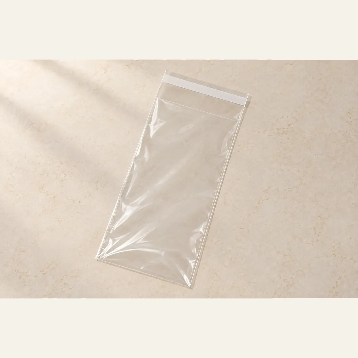 Clear Self-Seal Product Bag · 10 × 23 cm photographed on a warm neutral studio background