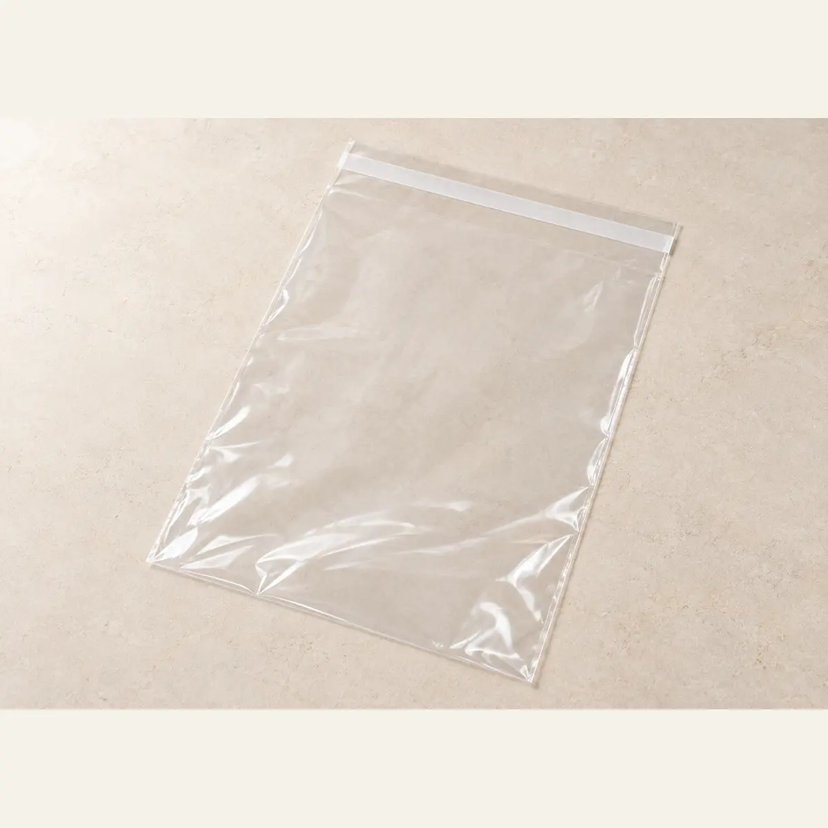 Clear Self-Seal Product Bag · 28 × 40 cm photographed on a warm neutral studio background