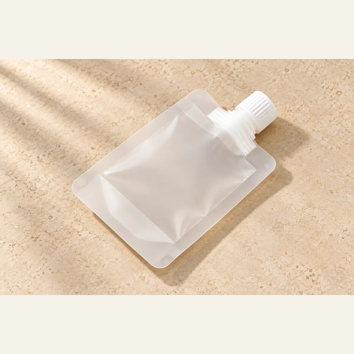 Refillable Travel Pouch photographed on a warm neutral studio background