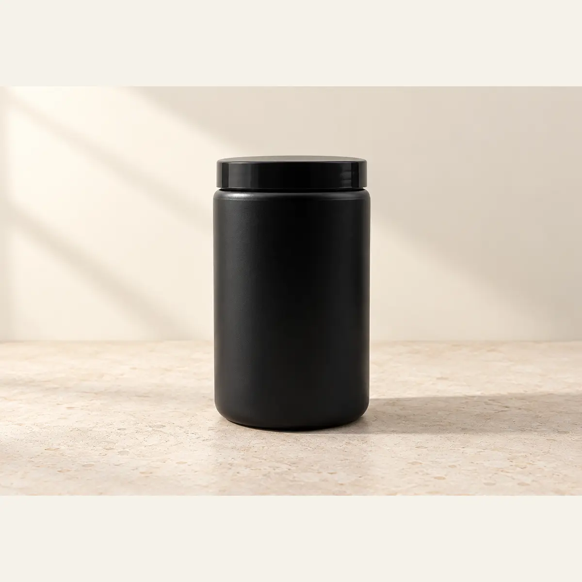 Black 750 g Jar photographed on a warm neutral studio background